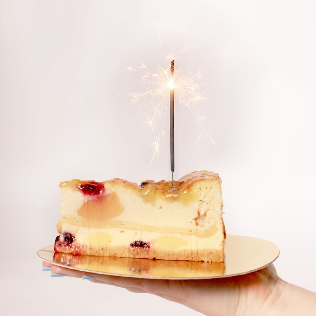 A slice of cake with a sparkler