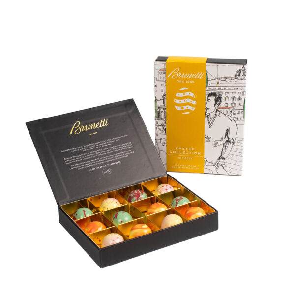 An open luxury chocolate box with easter-themed packaging and colorful egg-shaped chocolates, set against a white background.