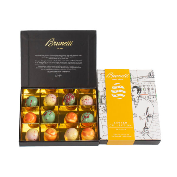 Open box of brunetti chocolates featuring a variety of decorative easter eggs, with the box's inner lid displaying the brand's history.