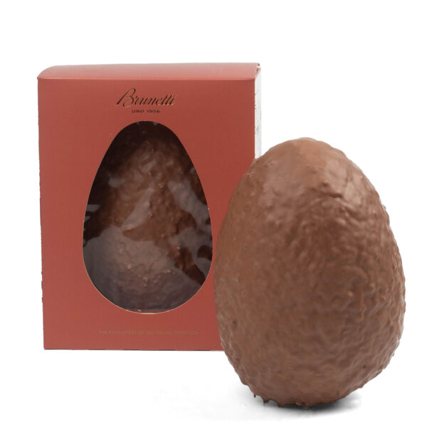 Chocolate easter egg next to its brunetti branded box with a clear window showing another egg inside.