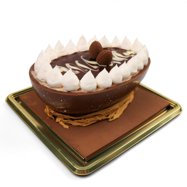 Gelato di Pasqua decorated with whipped cream peaks and a chocolate swirl design, presented on a golden tray.