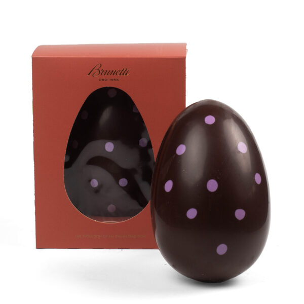 Chocolate easter egg with pink polka dots next to its packaging box labeled "brunetti.