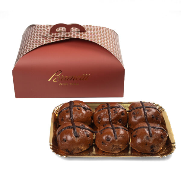 Nutella Hot Cross Buns .A red takeaway box with a logo alongside a tray of six chocolate-covered pastries decorated with dark drizzles.