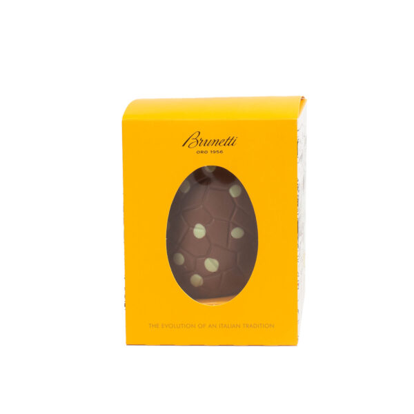 A yellow brunetti chocolate egg box with a clear window displaying a dark chocolate egg with white decorations, labeled "the evolution of an italian tradition.