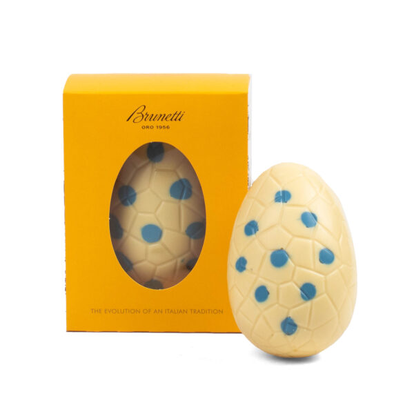 A brunetti chocolate easter egg displayed next to its yellow packaging labeled "the evolution of an italian tradition.