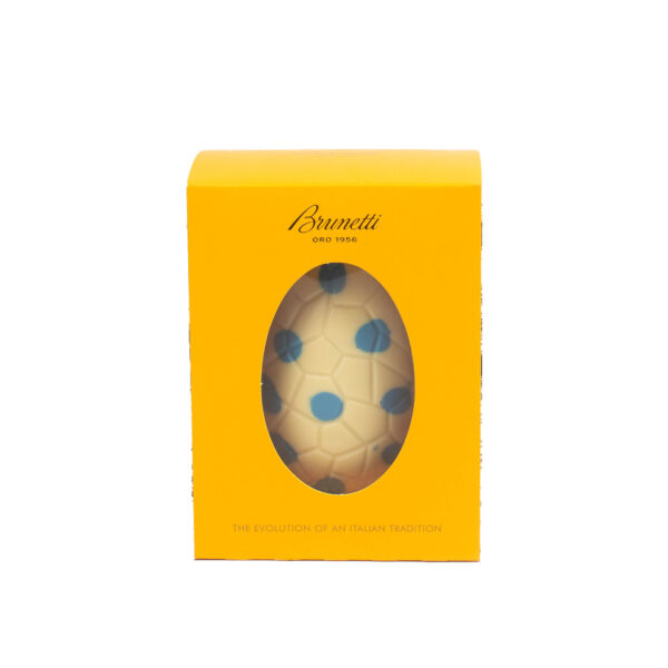 A yellow brunetti chocolate box featuring an egg-shaped window displaying blue patterned chocolates, labeled "the evolution of an italian tradition.