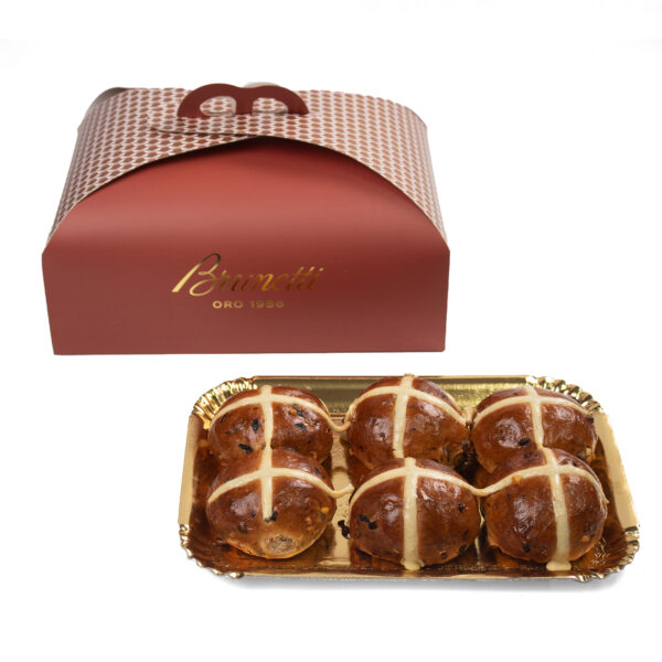 Nutella Hot Cross Buns .A red takeaway box with a logo alongside a tray of six chocolate-covered pastries decorated with white drizzles.