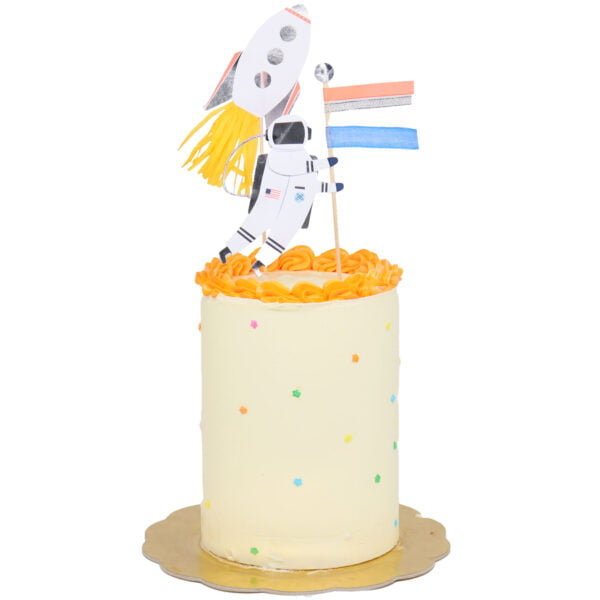 A cake with a rocket and a flag on top.