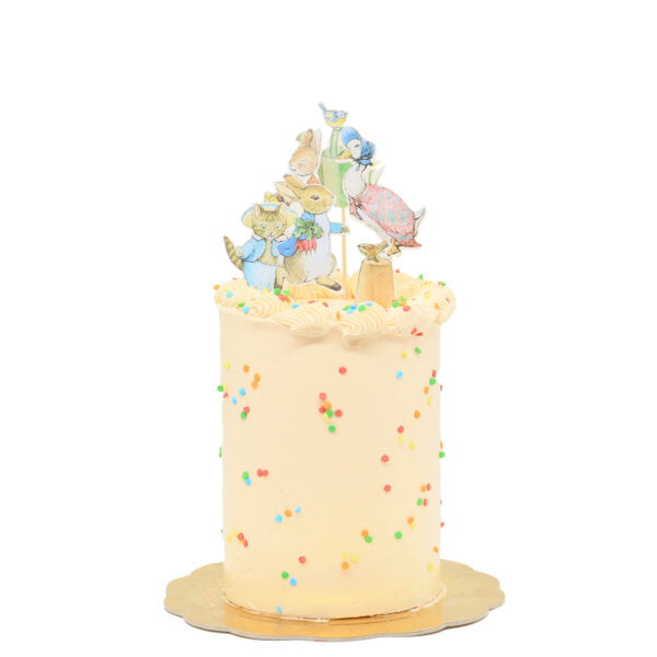 A birthday cake with a teddy bear on top.