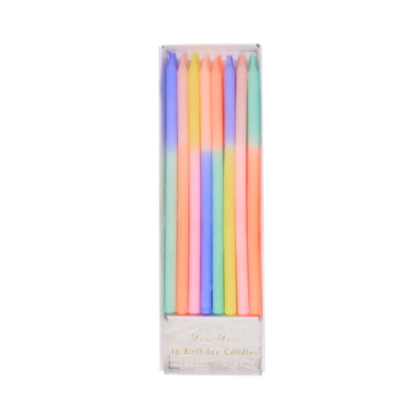 A set of rainbow colored candles in a box.