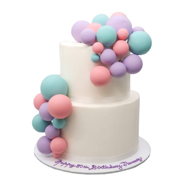 A birthday cake with Bubble balloons on top.