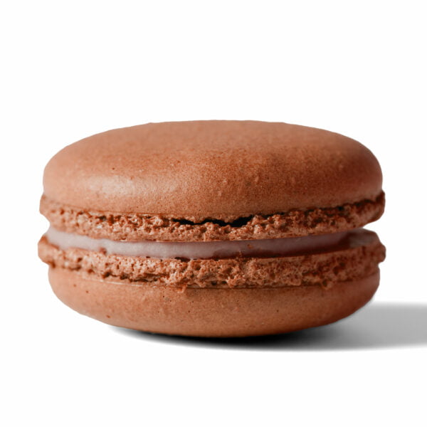 A chocolate macaron on a white background.