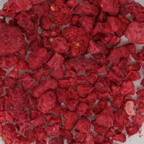 Raspberries in a bowl on a white surface.