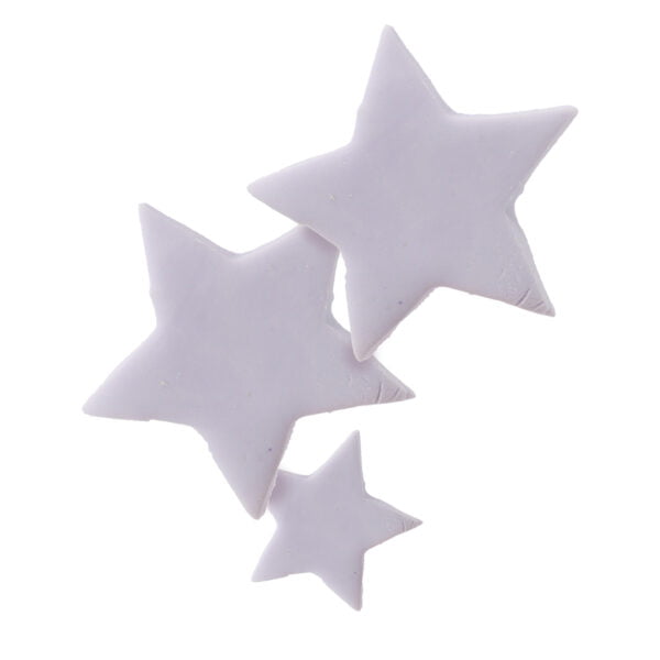 Three white plastic stars on a white surface.