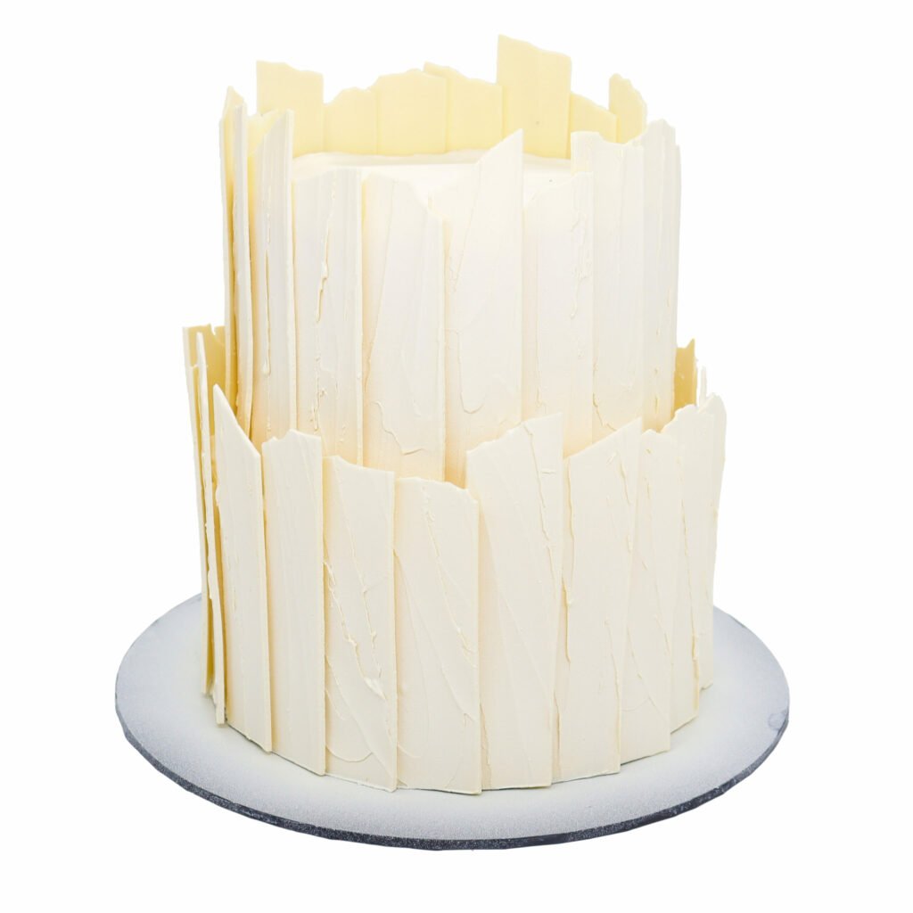 A white cake with white stripes on top.