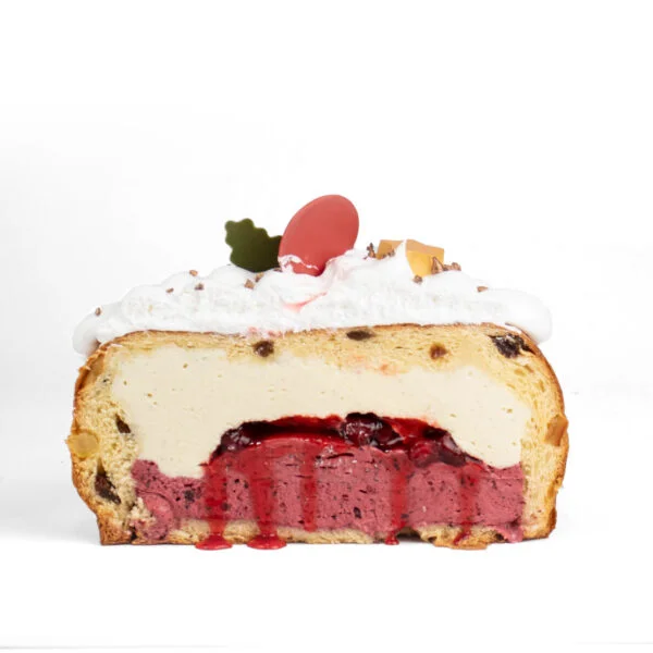 A cross-section of a layered dessert with a creamy top, fruit filling, and dense base against a white background.