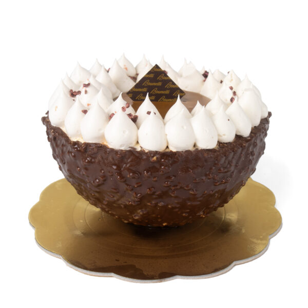 A decadent chocolate dessert shaped like a bowl, covered with nuts and topped with numerous small whipped cream peaks, on a gold base.
