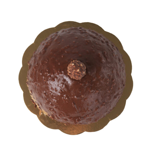 A chocolate glazed cake with a single Ferrero Rocher on top, presented on a golden cake board, viewed from above.