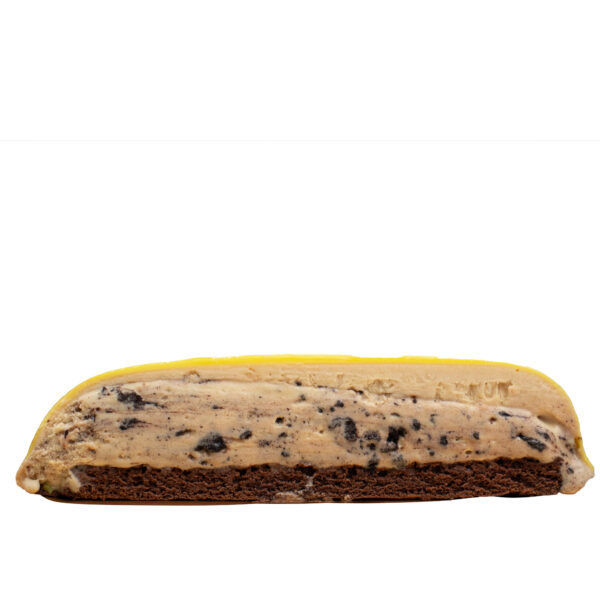 Cut layered dessert with a chocolate cookie base, cookies and cream filling, and bright yellow coat on top. isolated on a white background.