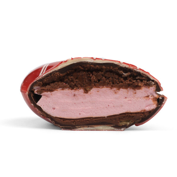 A chocolate-covered pastry sliced in half, revealing layered chocolate and pink cream filling, isolated on a white background.
