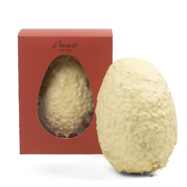 A large, white chocolate easter egg with nuts, placed in front of its red packaging box labeled "brunetti.